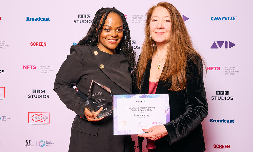 two people posing for camera with award and certificate